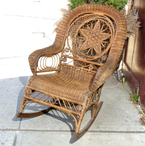 Heywood Wakefield wicker rocking chair in natural brown wicker.  Intricate star design on back, very comfortable.