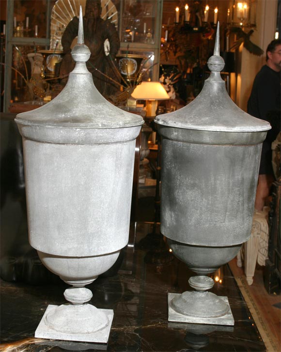 A grand pair of elongated covered zinc urns with final handles