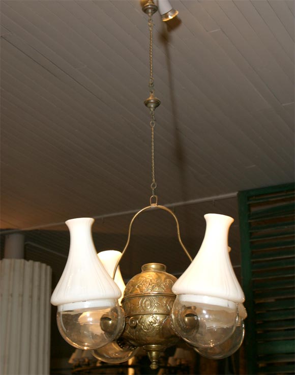 kerosene chandelier<br />
unusual 'angle lamp' form <br />
milk glass shades<br />
brass font<br />
(chandelier chain not included)