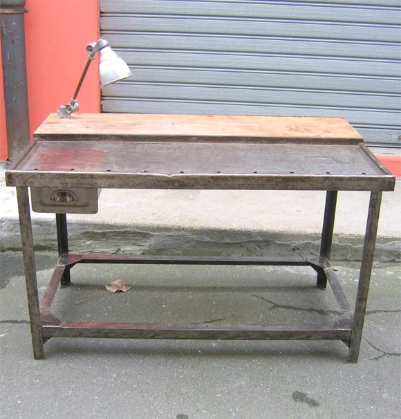 1950s industrial table in metal with wooden top surface and integrated articulated lamp. One drawer.