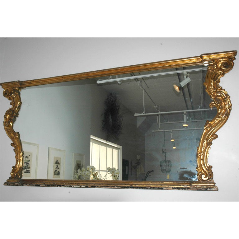 Large-scale giltwood over mantel mirror.