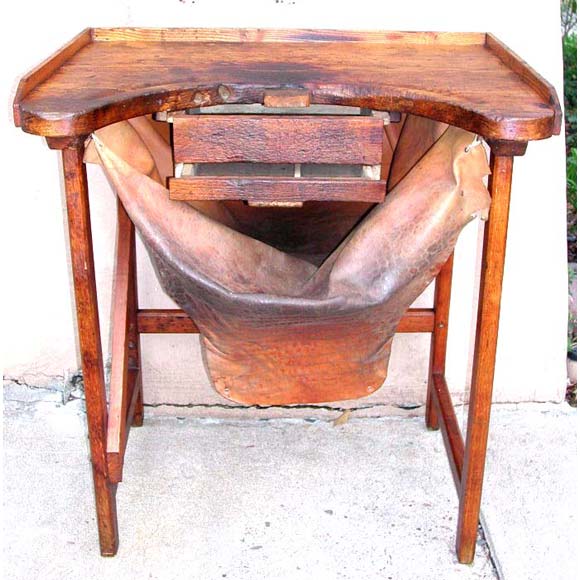 French wooden jeweler's work bench with leather apron.
