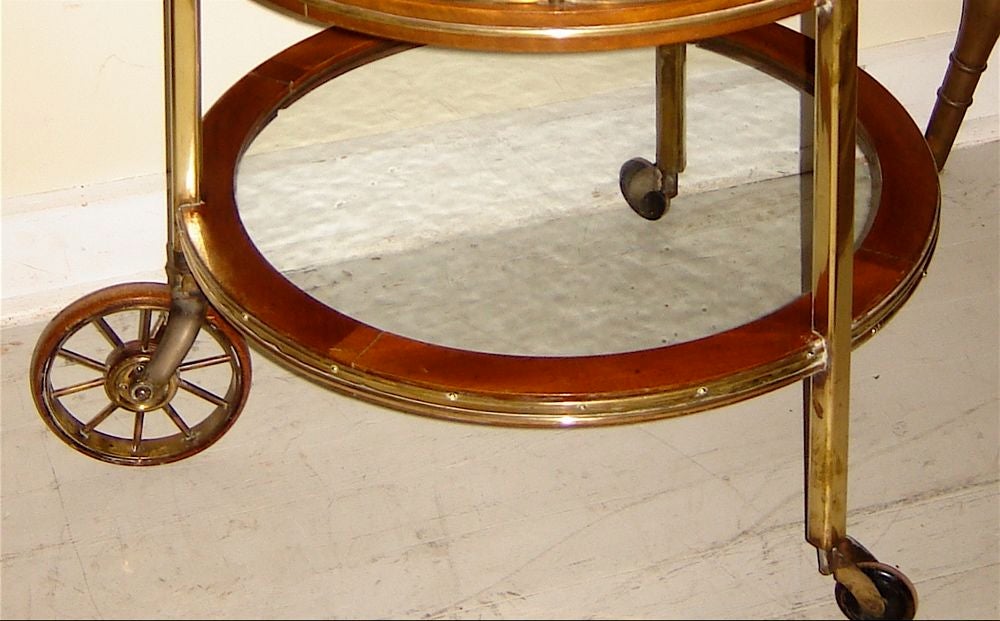 Brass and mahogony tea trolley with removable glass tray. Doors open to allow access to interior.