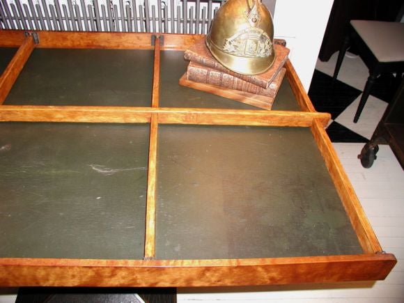 Burls eye maple ship captain's table with removable dividers. Original oil cloth is in fair condition, with a few tears. Could be replaced with leather.