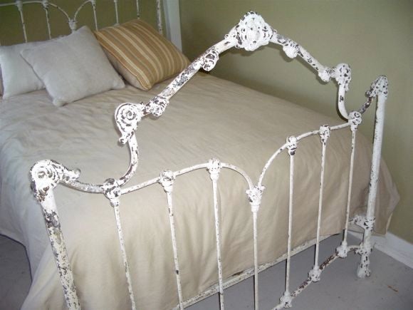 White iron bed with patinated old paint. Fits a double (full) mattress. (Interior dimensions are 54 x 76.5)