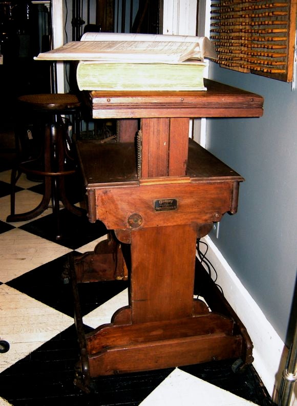 19th century adjustable box camera stand.Top raises and lowers, and there is a licking mechanism  for the wheels.  Would make a terrifiic TV stand.