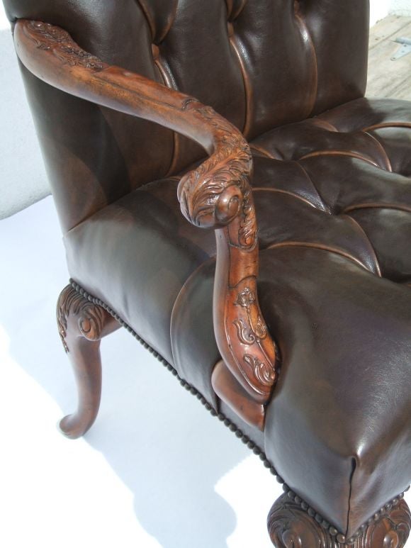 Hand carved, armed settee, buttoned leather back and seat.  Nail head