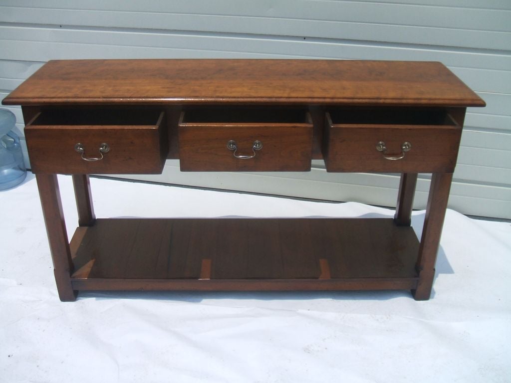 Cherrywood server with three drawers and a bottom shelf. 
Custom-made in England. Standard sizes: 6'L $5,290.00 7'L $5,520.00.