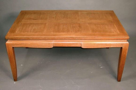 An Art Deco period oak dining table having a natural, ceruse finish. The top veneered in a parquet design. With 2 later closely matching 15