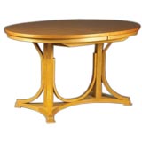 An oval, bent wood double pedestal dining table