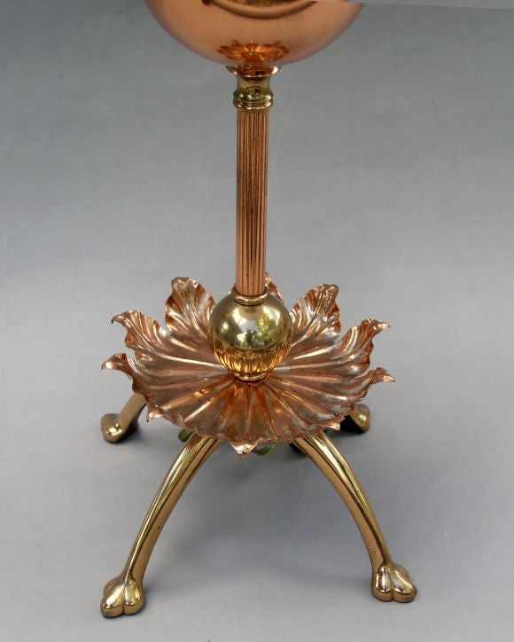 An Arts and Crafts period brass and copper oil lamp attributed to W.A.S. Benson. The copper elements retaining traces of original silver plating. England, ca. 1890. Converted to electricity.<br />
Benson was the most prominent designer of lighting