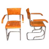 Pair of tubular metal arm chairs