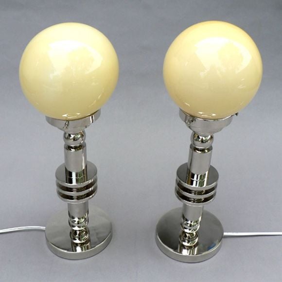 A pair of Modernist period chrome table lamps with glass shades, England.