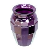A faceted aubergine colored glass vase