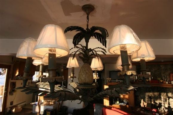 This lovely chandelier was originally one of two designed for a Manhattan Hotel.  The arms are palm fronds cut of metal as are the pineapple leaves and beau-beces.  The pineapple itself is carved of wood.