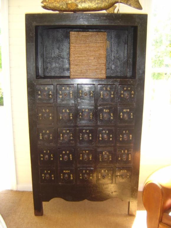 Pair of Dark Lacquered Chinese Medicine Cabinets with Open Top Shelf and Chinese Characters on 25 Drawers<br />
41
