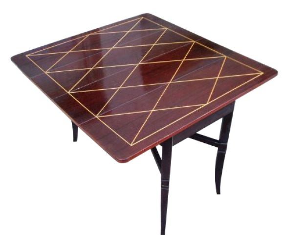 Tommi Parzinger drop leaf extension dining table in mahogany with diamond shaped maple inlay.

Tommi (Anton) Parzinger (1903-1981) was born in Munich and received professional design training there at the Kunstgewebeschule (School of Arts and