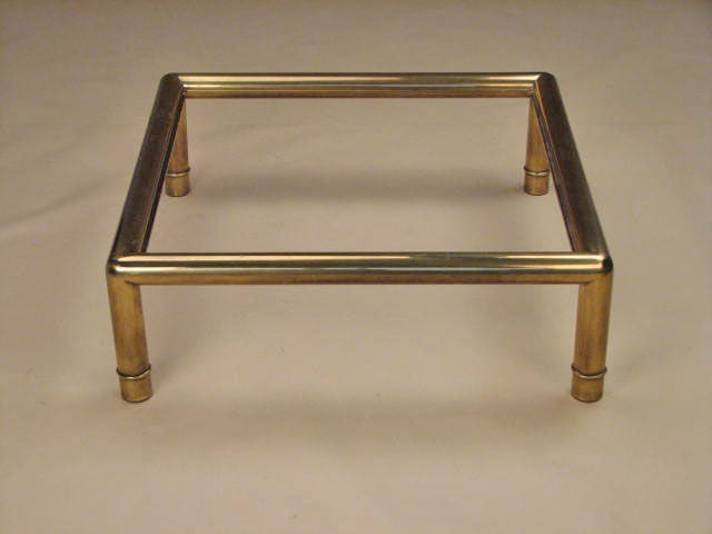 Coffee table in thick tubular brass with bronze lacquer and inset glass top by Mastercraft, American 1970's