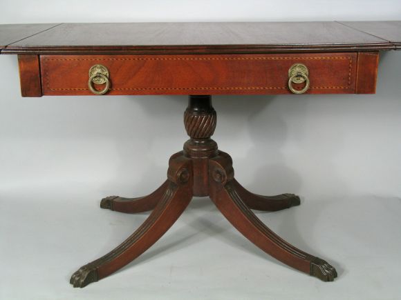 #8-221 A drop leaf mahogany table with inlay pine accents on a single drawer .Brass feet.