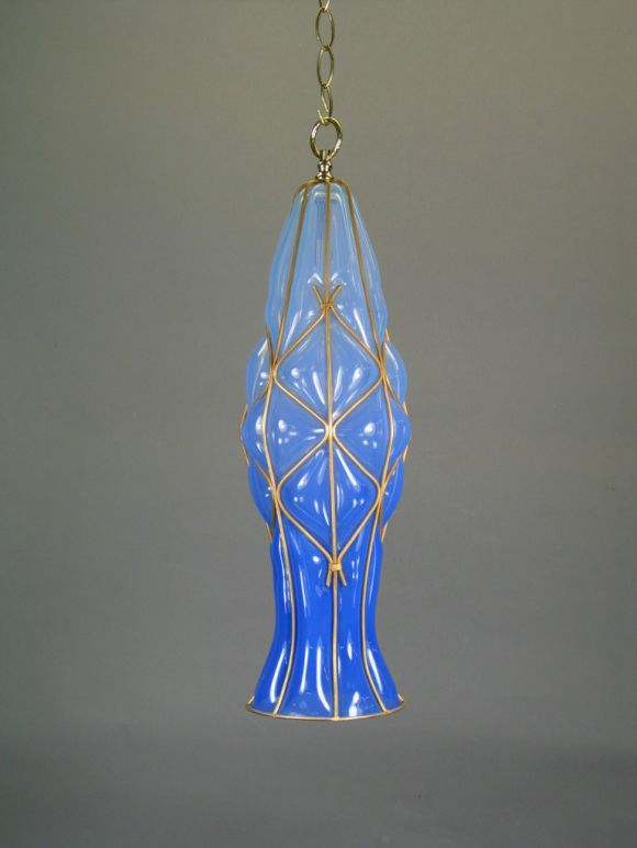 Handblown Murano blue glass in a metal frame pendant.