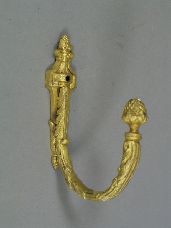 Five bronze coat hooks (two sets available)