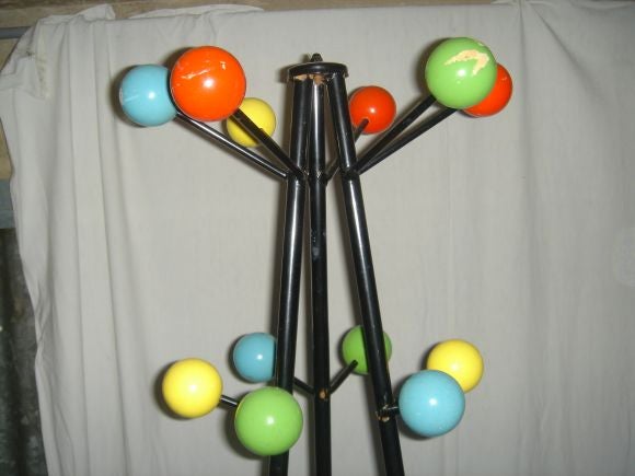 pair of coat stand sin metal with painted wood balls from the 1950's