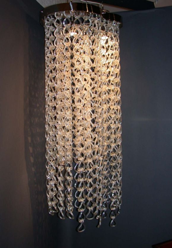 A rare 1960s original 6 foot Murano chandelier with handblown rings (in a combination of clear and striped rings.)
Dimensions of the actual upper violin shape support is 28