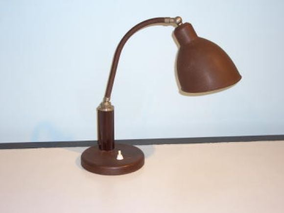 Painted metal with textured finish. Brass mounts and bakelite column detail. Adjustable pivoting arm & shade.  Second matching lamp available.  Priced per lamp.