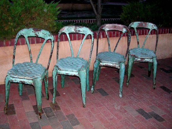 Exquisite set of four French stacking bistro with their original patina and rattan peel seats.