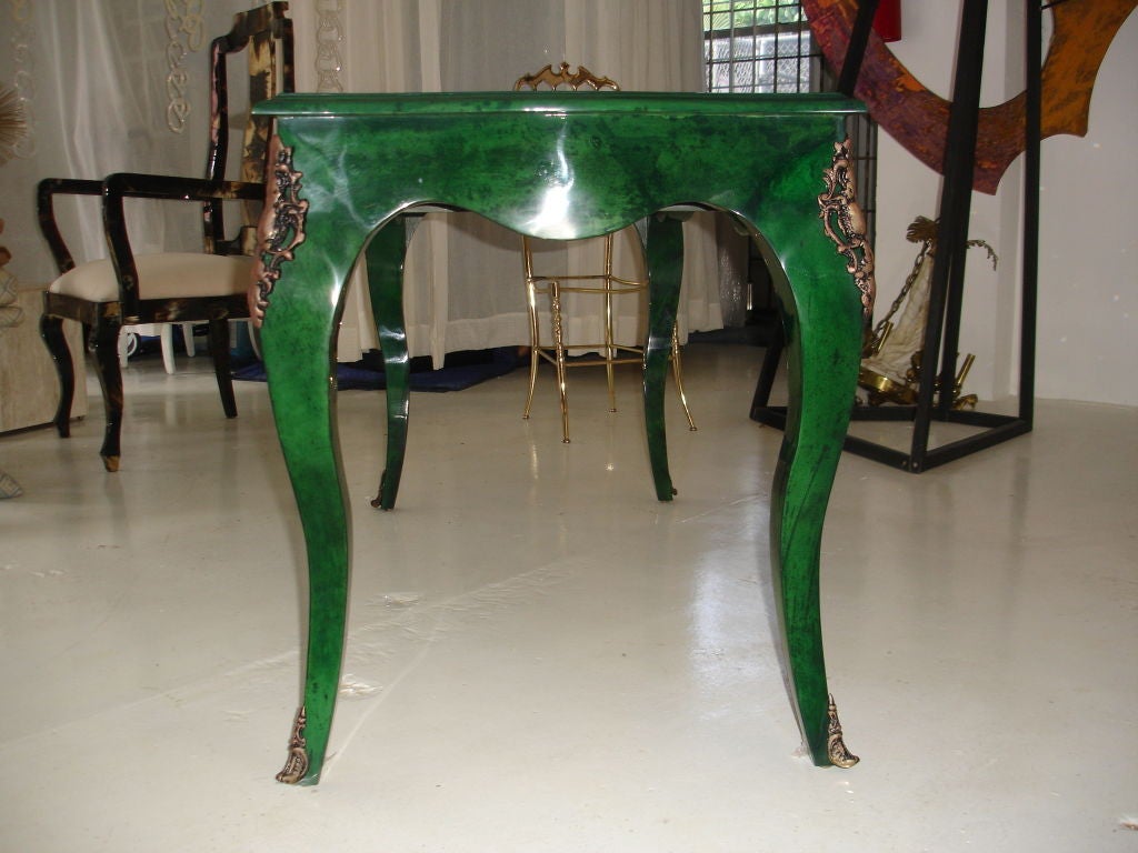 A most unusual take on a classically styled french desk. The case in covered in a beautiful shade of green parchment and wondreful brass line inlay to drawers. The workmanship of the parchment is fantastic