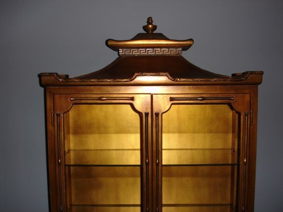 An Asian style gilt decorated curio in the style of James Mont.