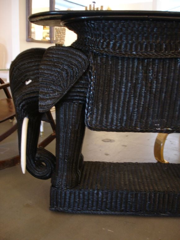 A black painted wicker bar in the shape of an elephant.