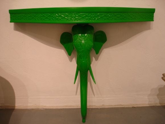 A pair of diminutive elephant console laquered green.