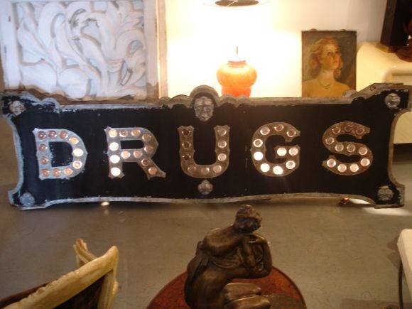 A great old sign. Painted metal inset with purple glass 