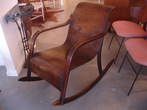 A simple and modern looking rocking chair in the style of Alvar Alto.