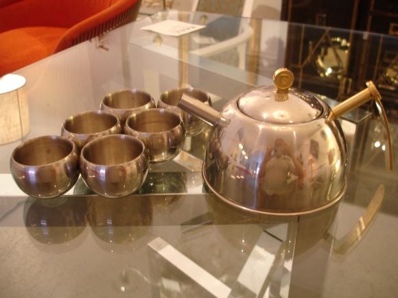 An unusual tea set comprising of a tea pot and sic cups. Beautiful two tone having a brass handle and finial with the Pierre Cardin Logo