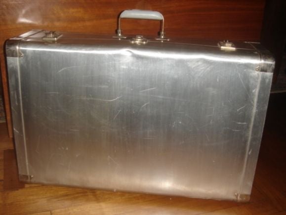 A vintage aluminum suitcase.  Circa 1930.  Made by Cheney, England.  Signed.  Fully operational locks.  Lined in green satin.