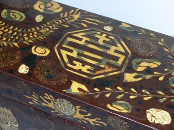 A MYTHICAL KOREAN ART DECO RECTANGULAR FAUX TORTOISE TÊTE-DE-NEGRE LACQUER CABINET INLAID WITH MOTHER-OF-PEARL AND SHAGREEN PHOENIX AND DRAGONS.  The large intricately inlaid rectangular lacquer cabinet raised on a conforming base with scalloped