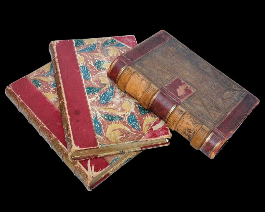 NOTE: we have many pther sets of books available- please see our website: www.edhardysf.com.  A PAIR OF ENGLISH 19TH CENTURY PAPER-BOUND BOOKS: 'ENGRAVINGS FROM THE WORKS OF SIR JOSHUA REYNOLDS' VOL. I AND II; ONE CONTINENTAL LEATHER-BOUND LEDGER