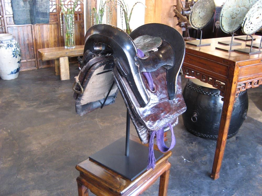 Meiji period (19th Century) Japanese Kura Lacquered Wood Horse Saddle with brass fittings, leather pads and tazuna silk rope.   Museum mounted on metal stand.  401367-195010