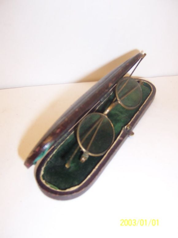 Old eyeglasses in the original case, a charming touch for a desk.