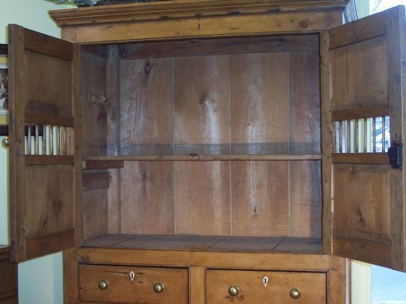 This is a terrific piece of pine, it is very charming and warm, and will lend a considerable personality to a room.  All original ivory escutcheons, wonderful panels(front and side) and a beautiful patina.  Brass knobs are replaced.<br />
<br