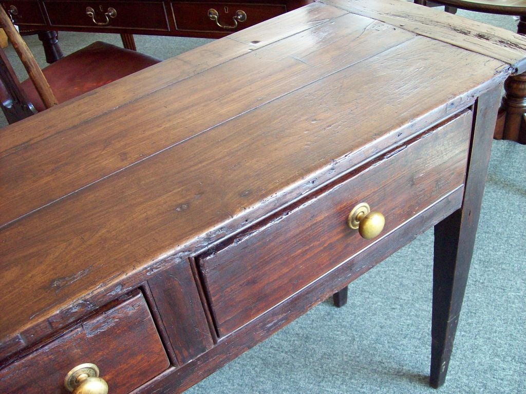 Antique three drawer server from France. The cherry has a warm, dark finish and is rich in wear and patina. The legs of this sideboard have been raised to a more useful height. Would make a fine sofa table.