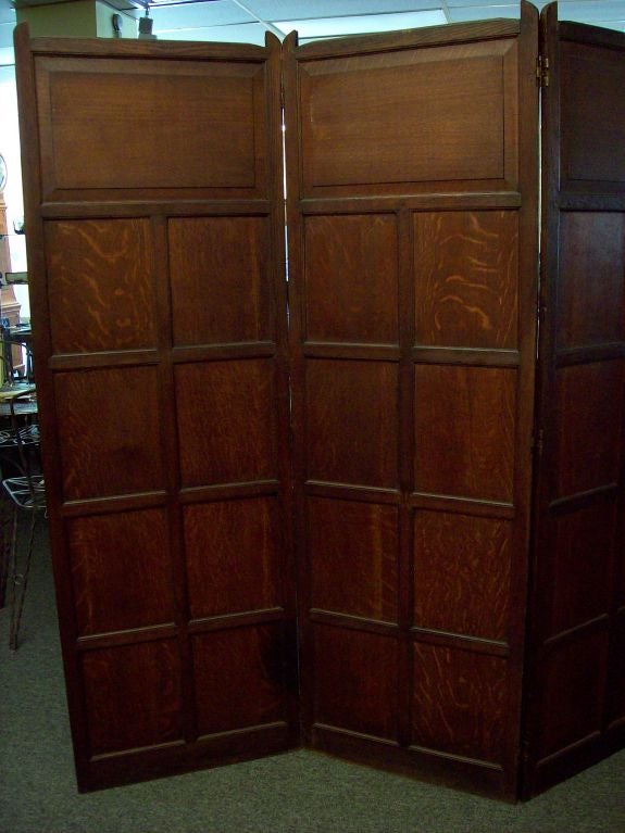 Antique three-fold two-sided screen from England. The top panels are raised panels, the remainder are flat. The oak has a warm, dark patina. Would make an attractive room divider. Hinges are original, folds easily for storage (each panel measures