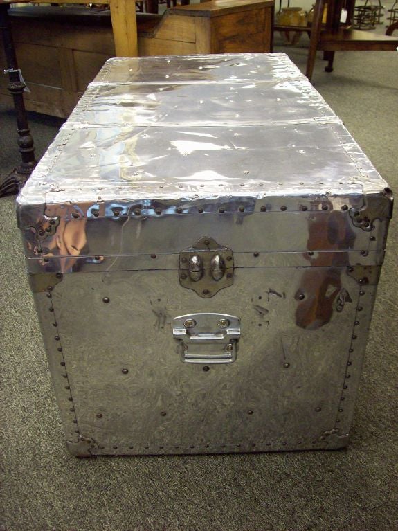 A large vintage aluminum trunk from England. Originally used as aircraft cargo luggage, this polished aluminum trunk would make a terrific coffee table since it is 21