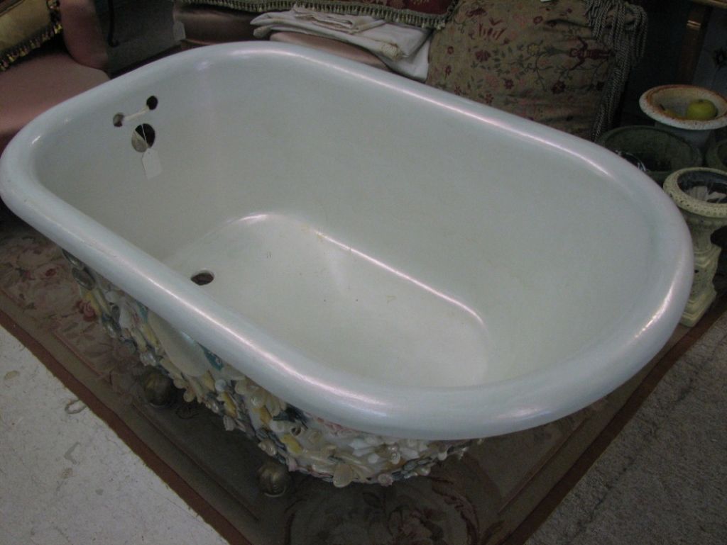 Enchanting bathtub covered in Mother-of-Pearl shells patterned to depict hearths, sea horses, ocean waves, hearts, whimsical flowers, and nautical anchor; gilded feet and iridescent interior. Easily adaptable to modern day plumbing.<br />
<br