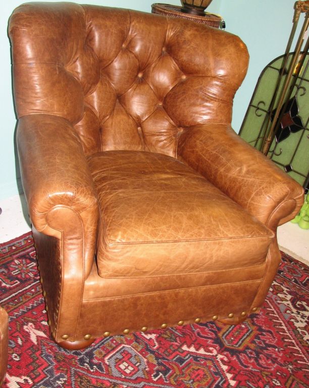 Ultra comfortable jumbo-sized leather club chairs with wood bone feet and tufted back. Upon request, a second pair can be made available.