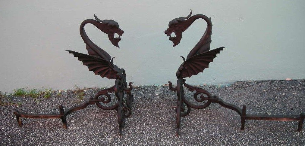 Matching pair of black painted wrought iron griffin andirons