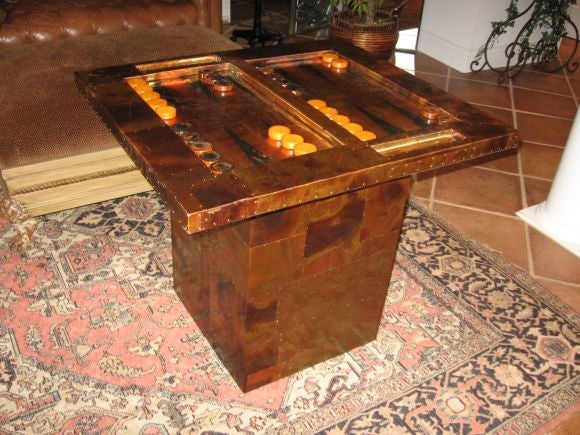 Custom designed all copper backgammon table in two parts, inspired by Paul Evans.  Base and top are all copper in a riveted patchwork effect.  Top is laquered to prevent scratching.  Leather cups, dice and doubling cube included.  Signed and dated,