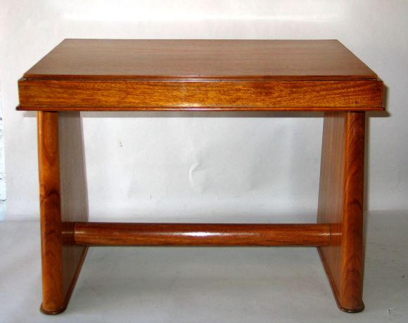 Elegant Bench / Occasional Table in Bleached Mahogany Typical of Modern Rational Style of Jacques Adnet during the Early Thirties. Two Sleek Tapering Legs are United by a Single Circular Stretcher and Support a Top with Graceful Lines. The Legs and